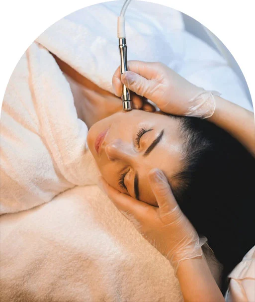 A woman receiving microdermabrasion exfoliation treatment
