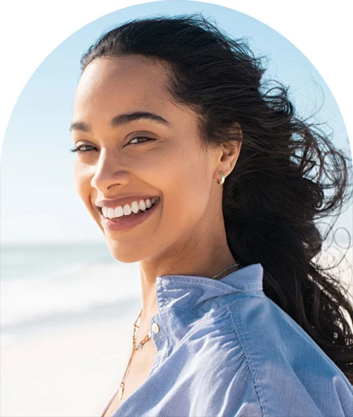 A woman on a beach smiling